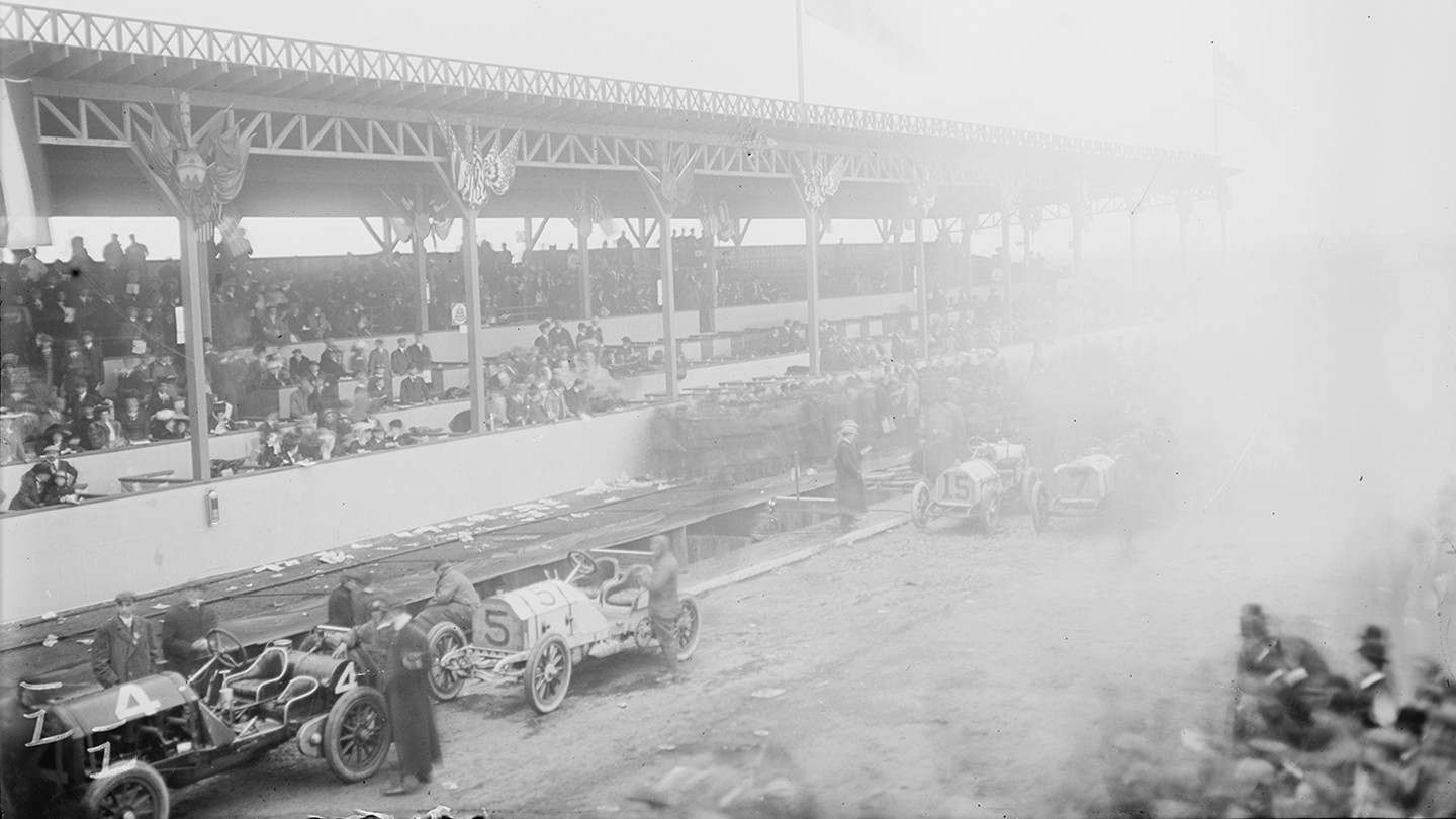 Black and white photo of a early model automobile race