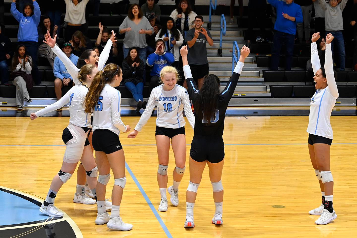 Johns Hopkins volleyball players celebrate