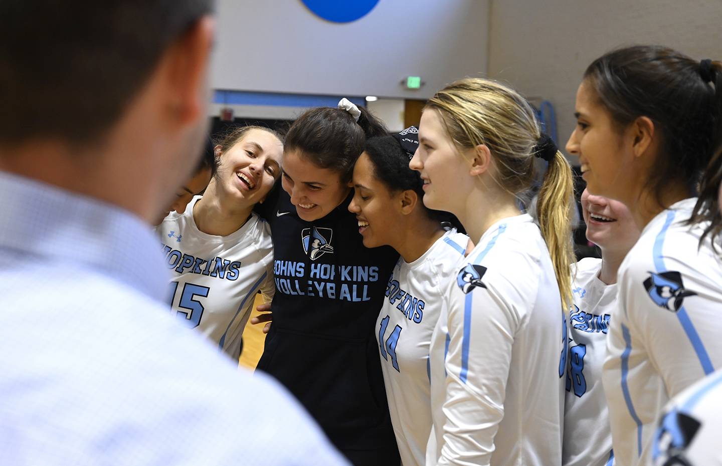 Hopkins volleyball players huddle
