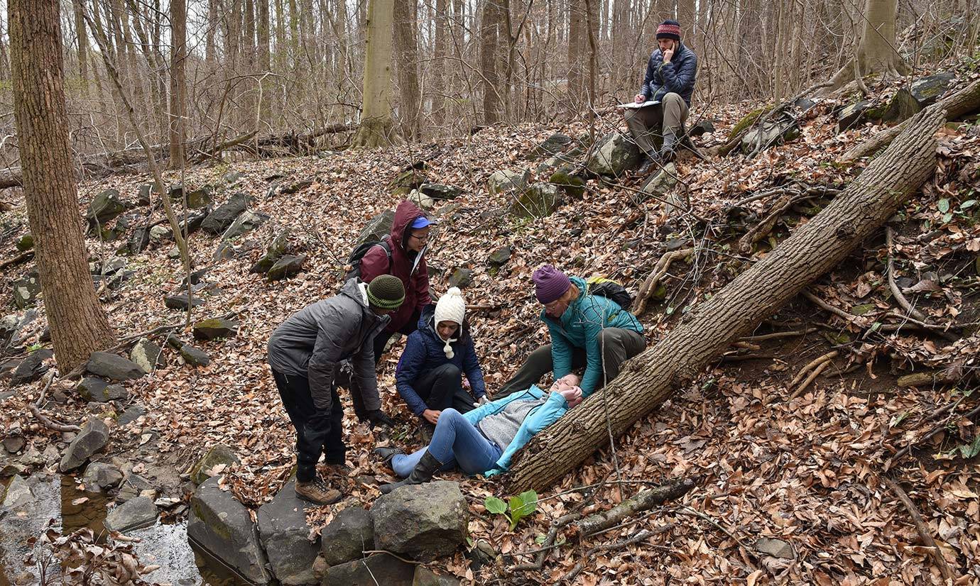 Group of students tend to an injured hiker