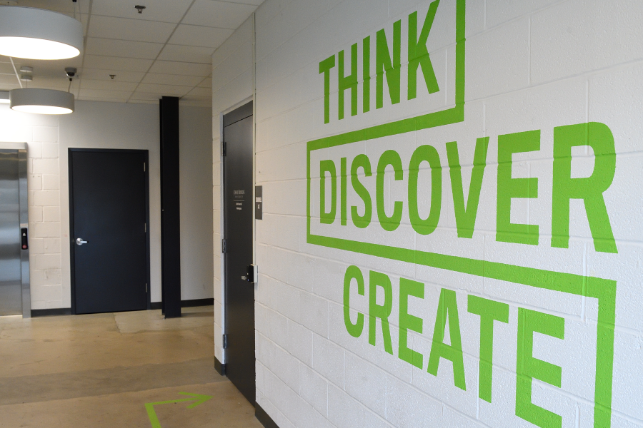 A wall mural that says Think, Discover, Create