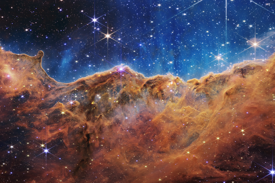 NGC 3324, a young star-forming region in the Carina Nebula, looks like mountains and valleys speckled with glittering stars