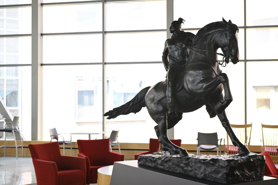 A statue of a Black man atop a horse stands in the center of Mudd Hall atrium