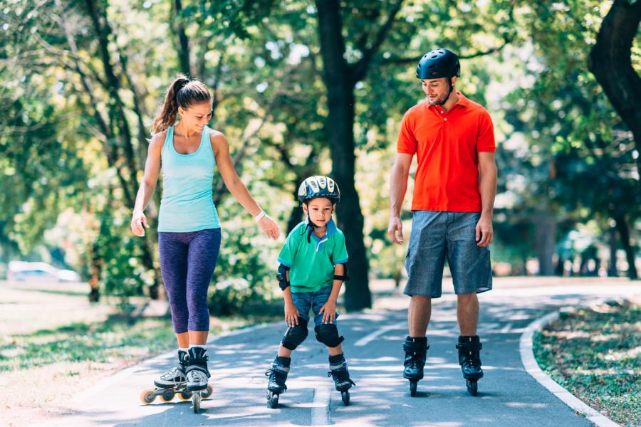 Mother and father and young son rollerskating