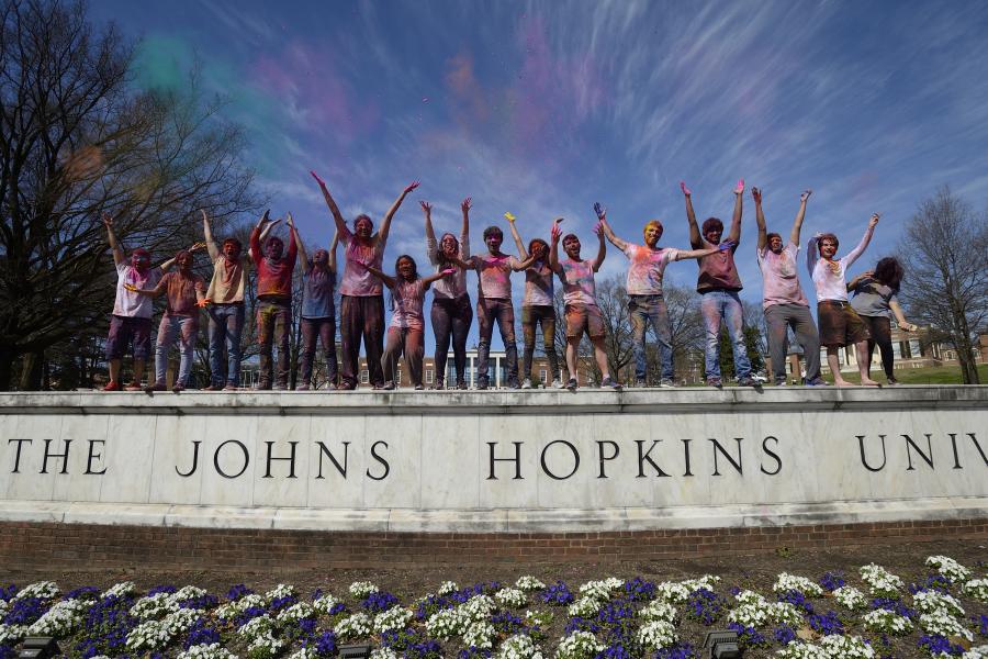 People on the Johns Hopkins wall sign