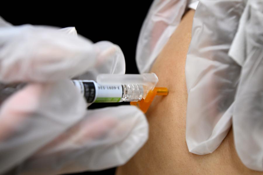 A flu shot administered in someone's arm