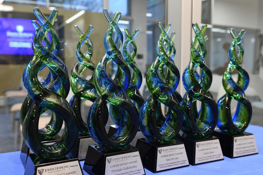 The Career Impact Awards are made of green and blue blown glass and have a plaque with each winner's name on it
