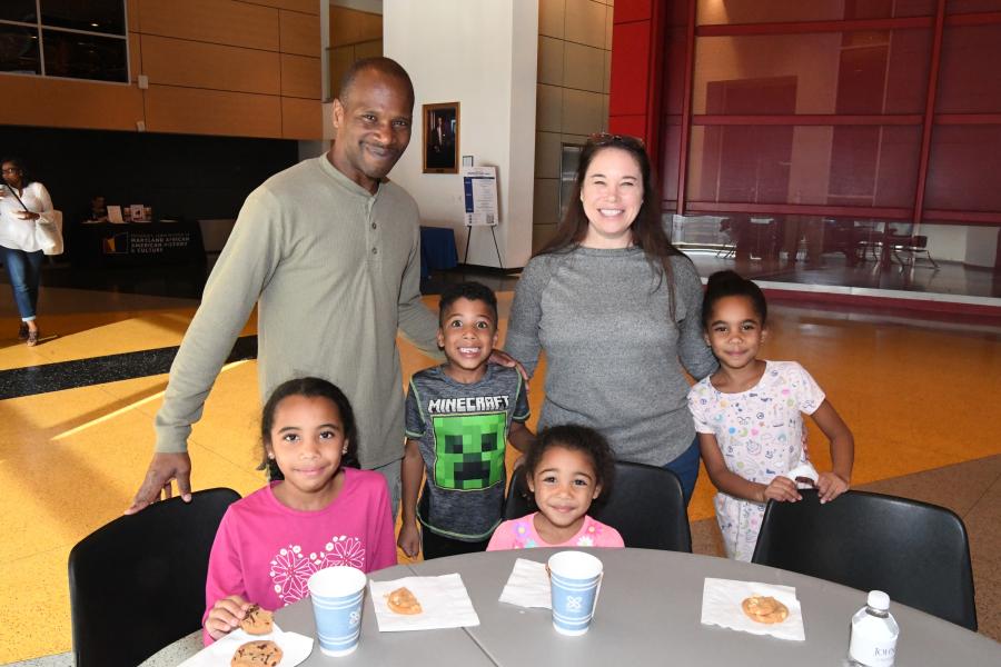 A family poses for a photo during Johns Hopkins Day at the Reginald F. Lewis Museum