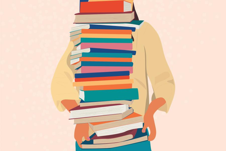 a woman holds a stack of books