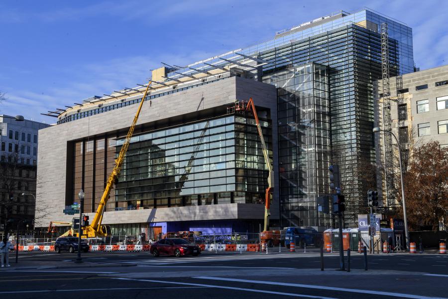 An exterior view of 555 Penn under construction in December 2022 with blue skies above