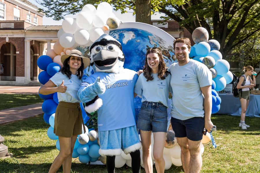 People stand with Jay the mascot