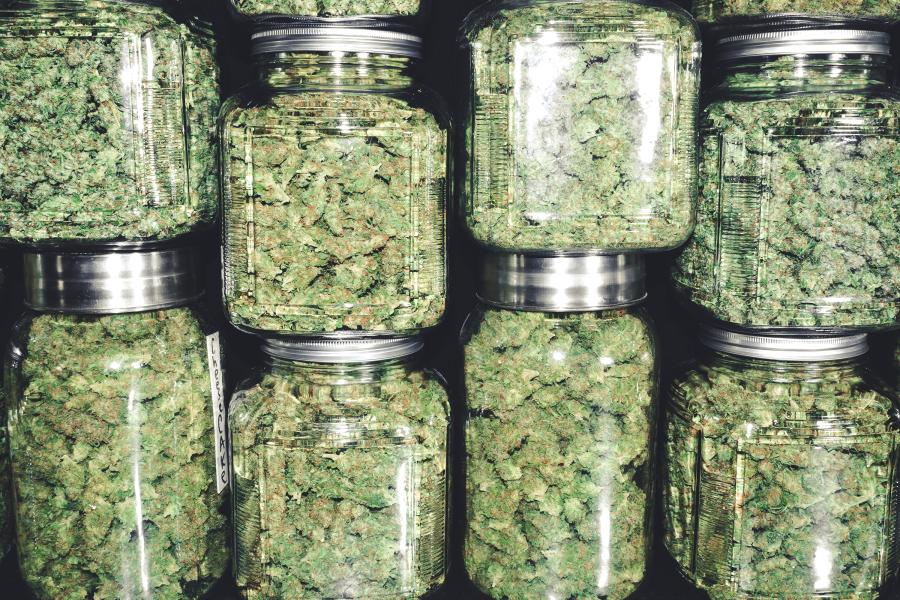 Marijuana buds in stacked glass jars for a dispensary