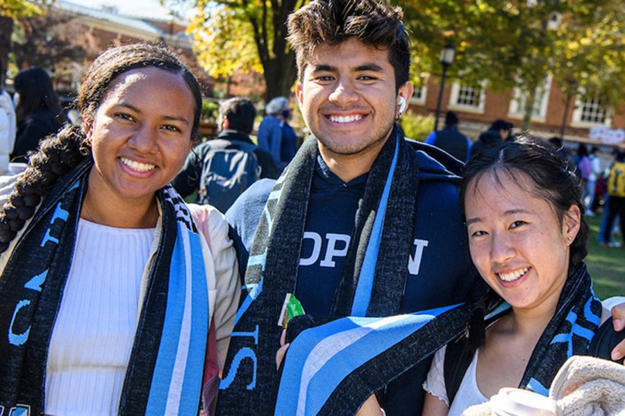 Three Hopkins students in blue scarfs