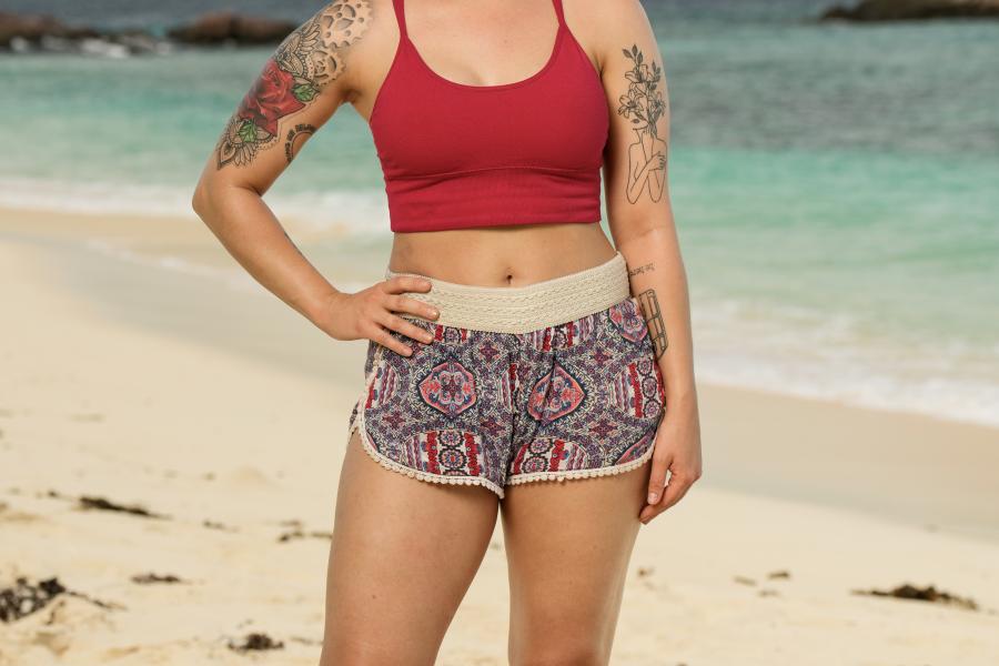 Photograph of Hannah Rose standing on a sandy beach in Fiji
