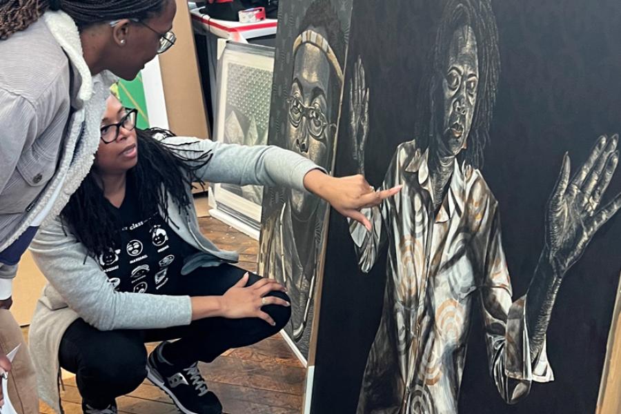 Johns Hopkins student and selection committee member Maya Kelsey Johnson, standing, and artist LaToya Hobbs look at a painting titled *How Johnetta Taught Us to Pray II*