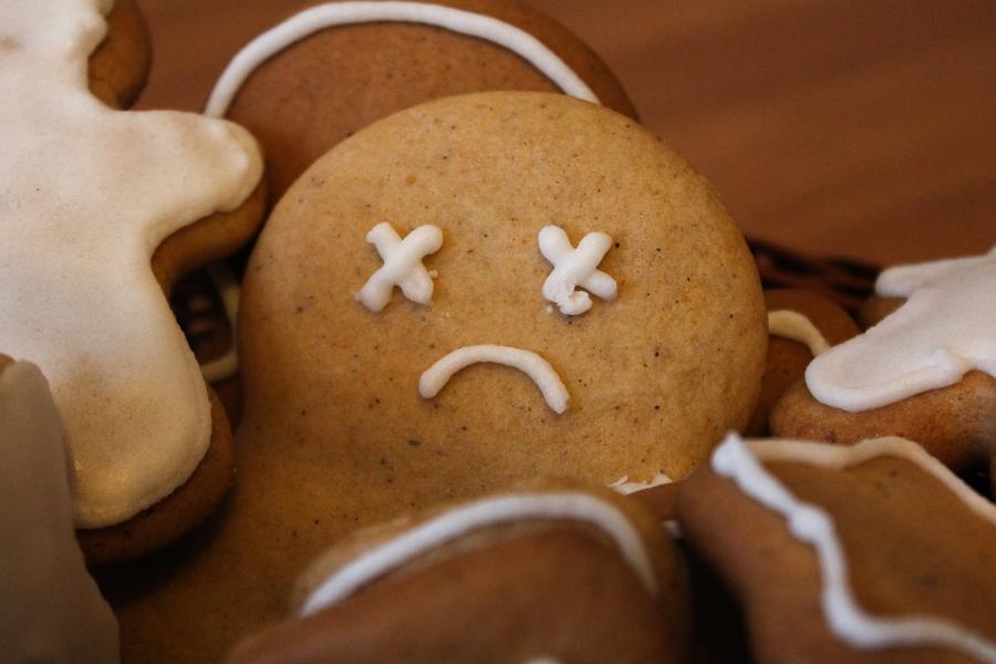 The head of a gingerbread man with Xs as eyes and a sad downturned mouth