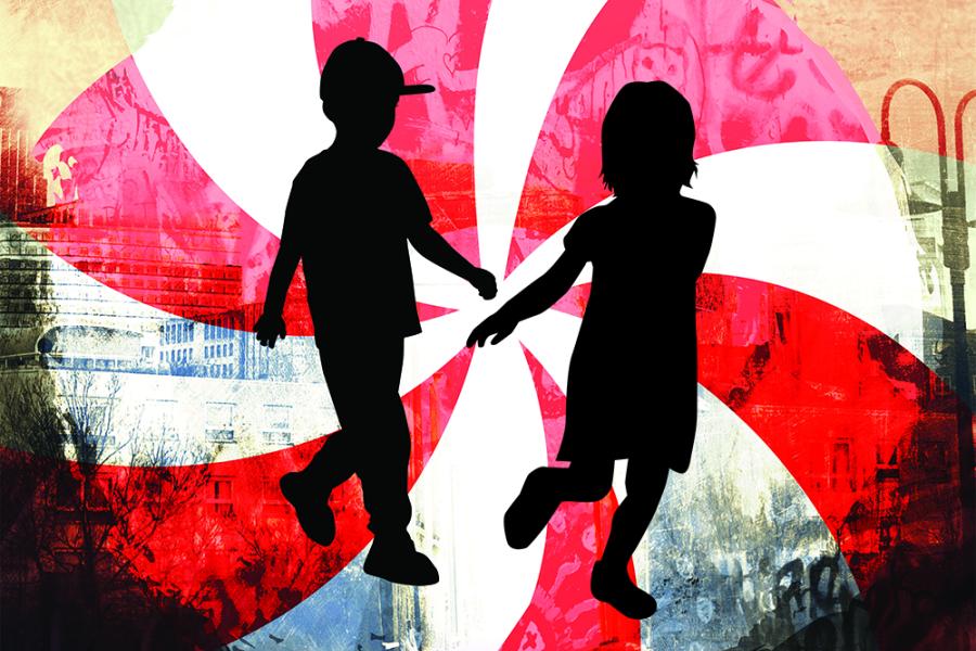 An illustration of the silhouette of two children with a large peppermint candy design behind them