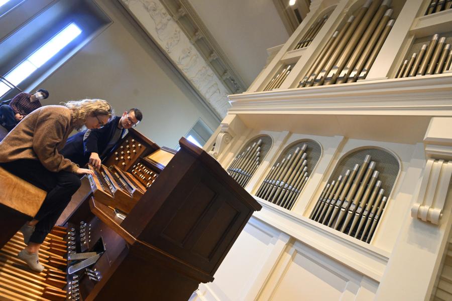 Jordan Prescott instructs a student as they play the pipe organ in Leith Symington Griswold Hall at Peabody Conservatory