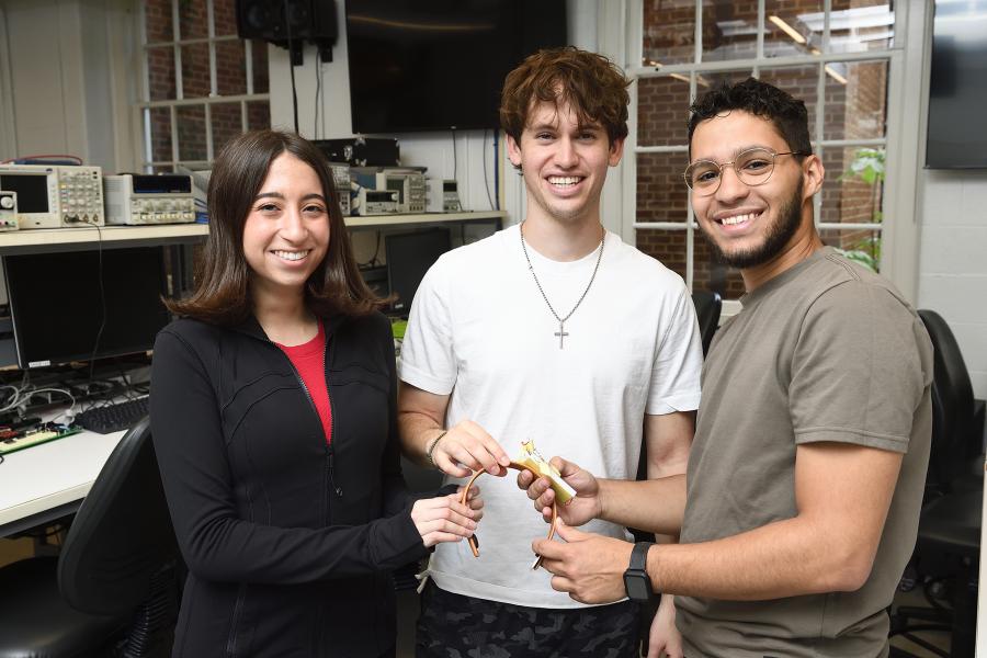 Engineering students hold their senior design project