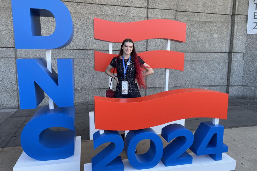 Kathryn Prather, age 18, stands in a 3D sign that reads 