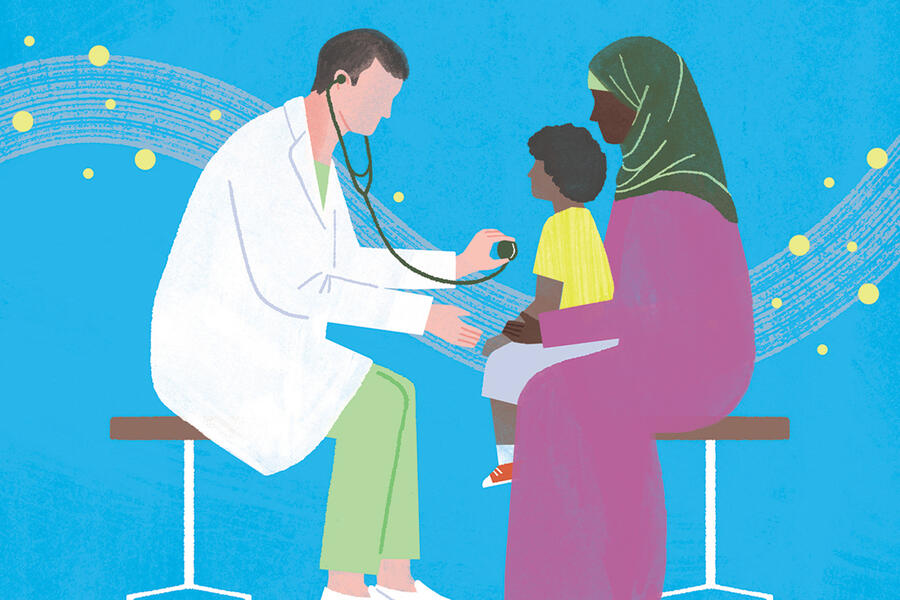 A doctor holds a stethoscope near a young patient on their mother's lap