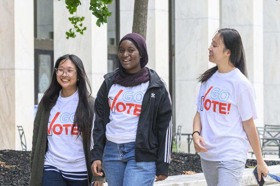 Three students wearing white shirts with 