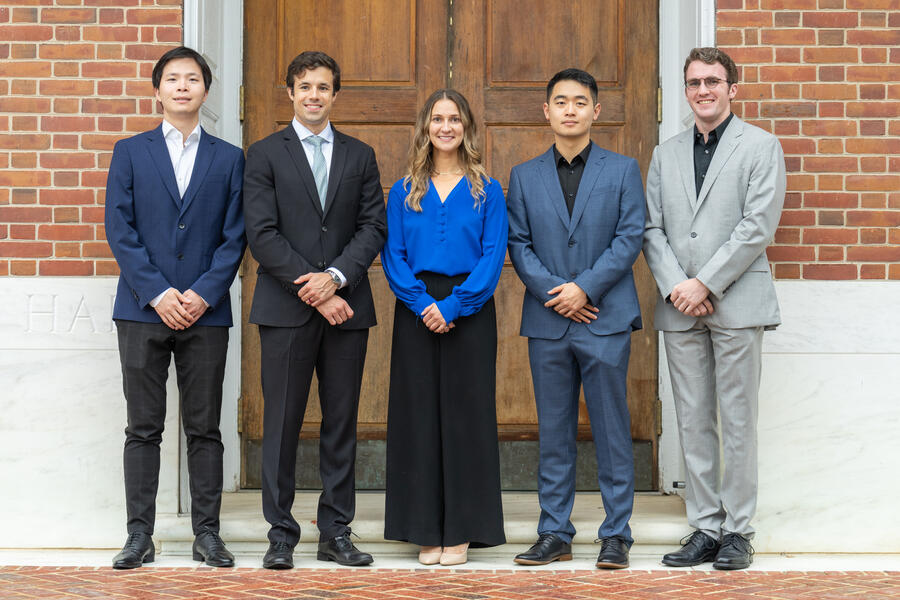 The 2025 class of Siebel Scholars pose in front of a brick wall. They are (from left) Jieneng Chen, Denis Routkevitch, Anastasia Georgiou, Fangchi Shao, and Benjamin Killeen