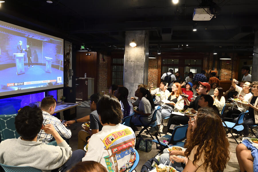 Students gather in front of a big-screen TV to watch the presidential debate on Sept. 10