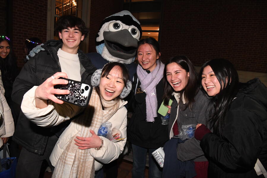 Five college students smile for a selfie with Jay the Blue Jay mascot.