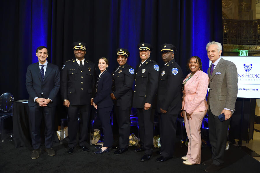 On Dec. 12, the inaugural members of the [Johns Hopkins Police Department](https://publicsafety.jhu.edu/community-safety/jhpd/) were sworn into service during a ceremony in the George Peabody Library. From left, JHU President Ron Daniels, Vice President for Public Safety and Chief of Police Branville Bard, Deputy Chief of Investigations Shayne Buchwald-Nickoles, Deputy Chief of Administration Rachel Jefferson, Captain Robert (Teddy) Reed, Lieutenant Marvain Wall, Officer Brionca Beard, and Chair of the Boar