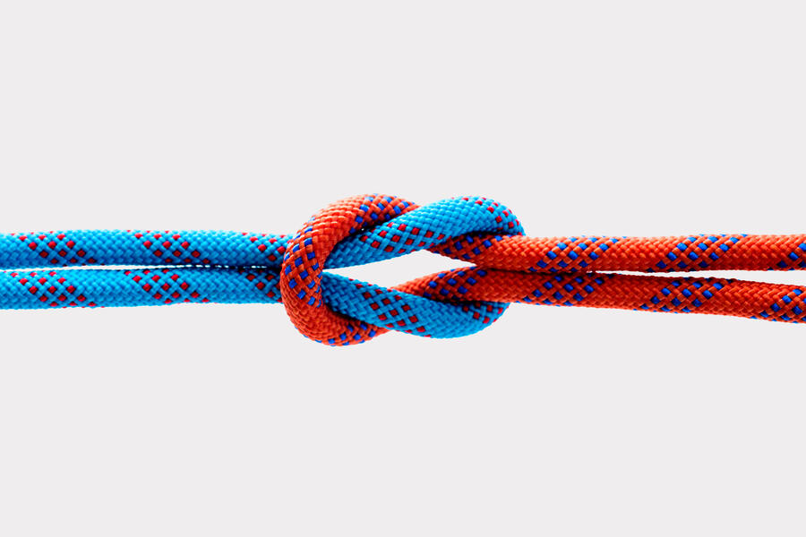 Rope with reef knot isolated on white background.