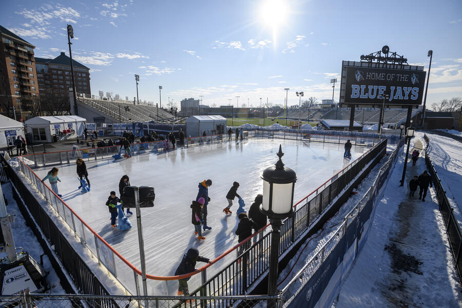 A photo of the Johns Hopkins Ice Rink in the mid-afternoon. In the background, a sign reads "Home of the Blue Jays."