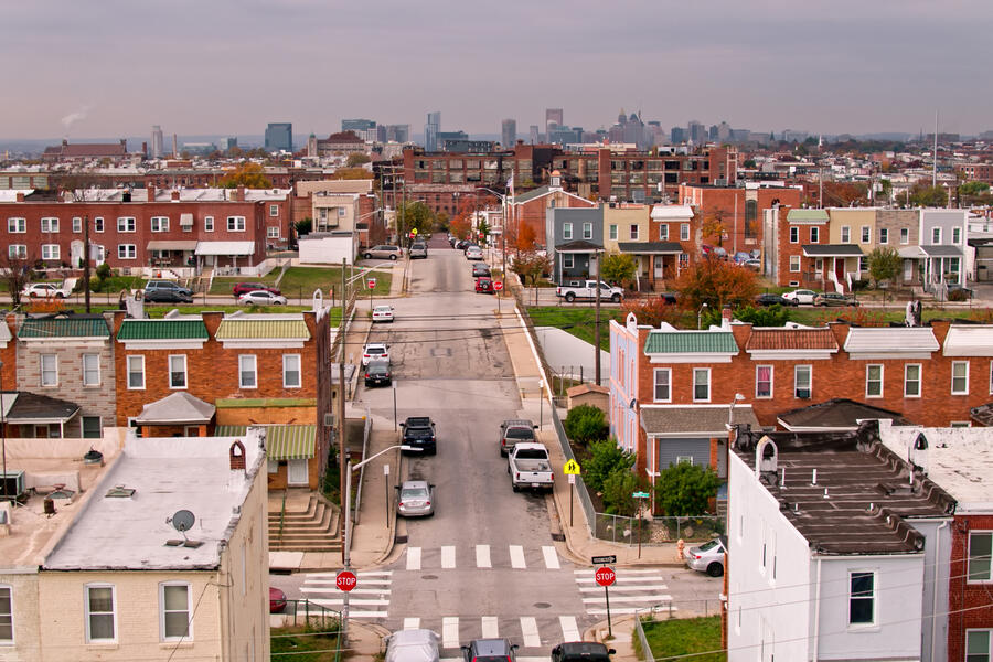 Aerial shot of Baltimore looking over residential streets in Greektown towards the downtown skyline