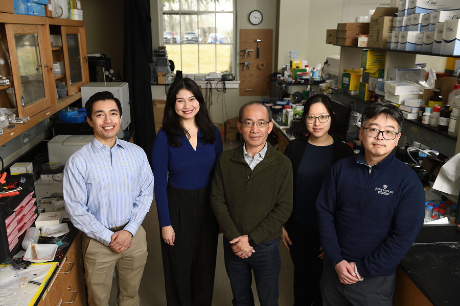 Tza-Huei (Jeff) Wang and members of his team stand in a lab