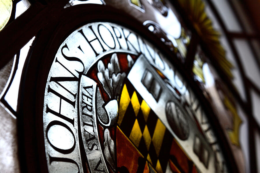 Close-up of Johns Hopkins University seal in stained glass