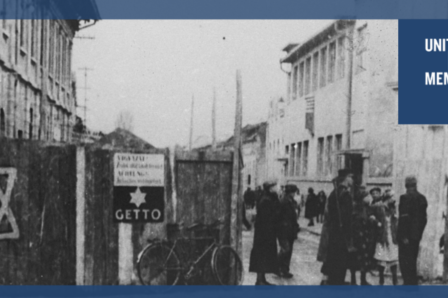archival image of a neighborhood labeled as a "ghetto" during WWII. A Jewish star is painted on a fence.