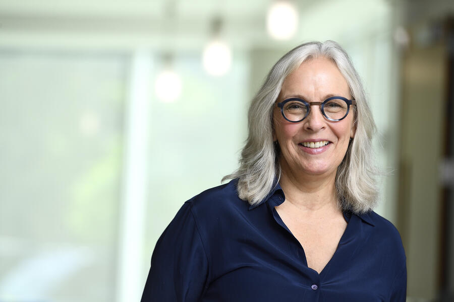 Photo of Gillian K. Hadfield, a while woman with light grey, shoulder-length hair and dark-framed glasses