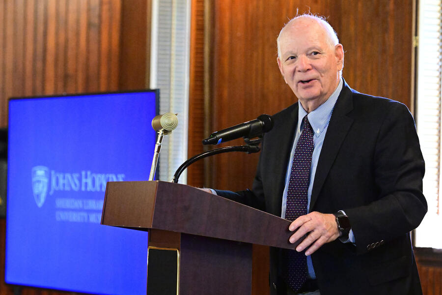 Sen. Ben Cardin speaks from a podium at Evergreen House