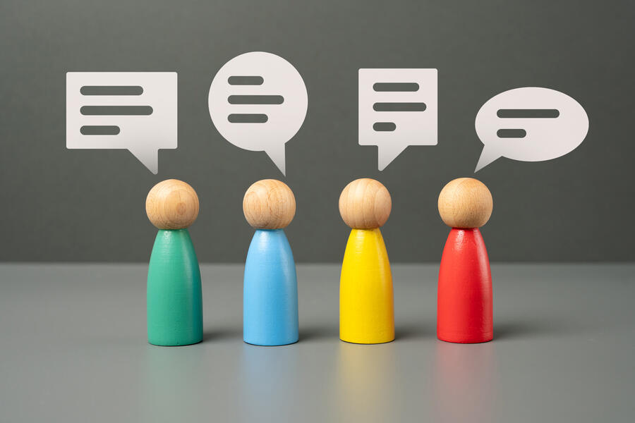 Wood figures with conversation bubbles over their heads
