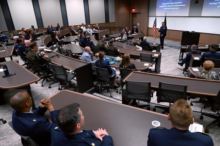 People wearing military uniforms inside of a lecture hall at Hopkins Bloomberg Center