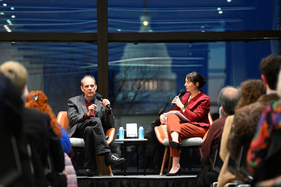 Arturo Casadevall, left, discussing his Wavelengths book, *What if Fungi Win?*, in March at the Hopkins Bloomberg Center
