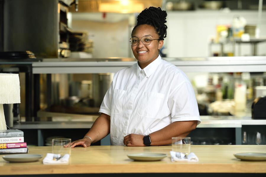Chef Jasmine Norton smiles for the camera while standing in her restaurant, the Urban Oyster.