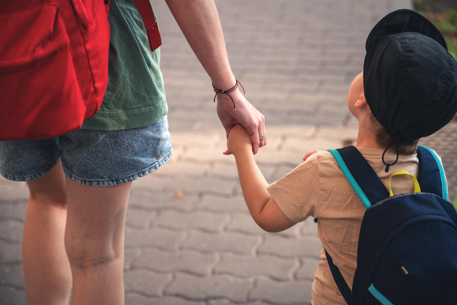 Mother walking her toddler to child care