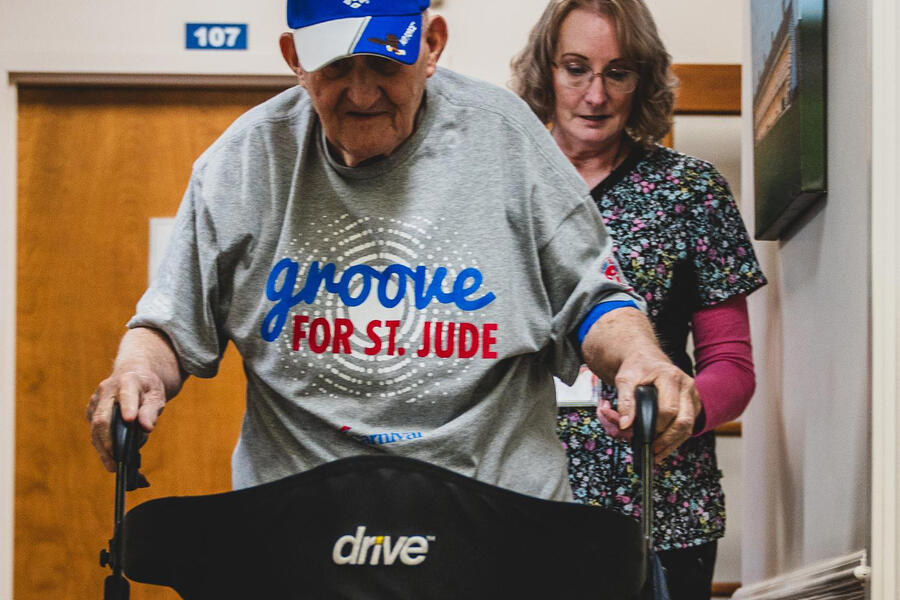 Frank Squibb uses his walker to make his way down one of the center's hallwaysFrank Squibb uses his walker to make his way down one of the center's hallways