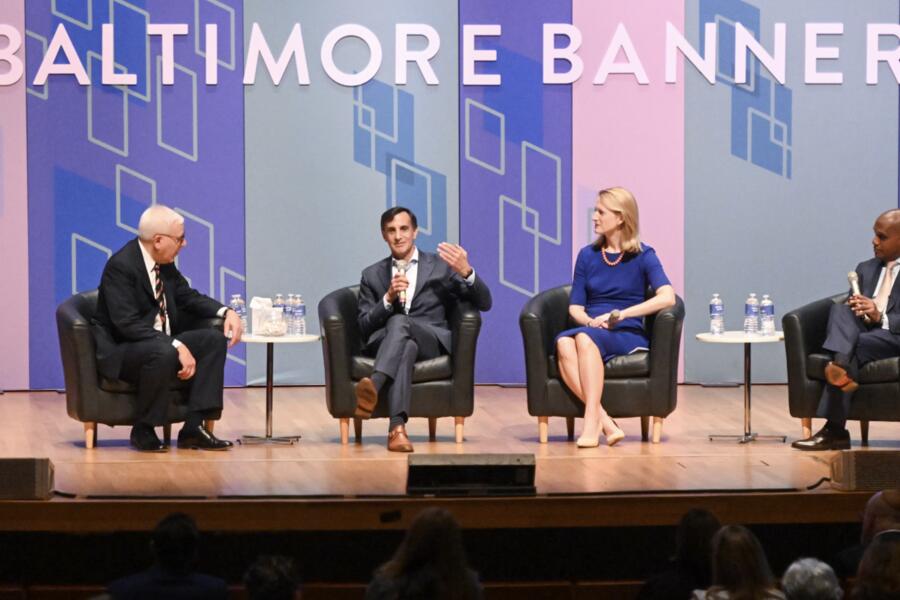 Four people sit on stage for a panel discussion