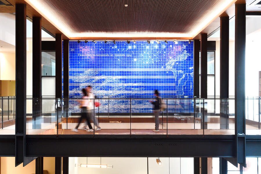 A blue tilework art piece in a modern building interior