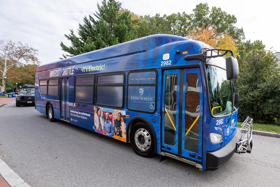 A blue electric bus in motion