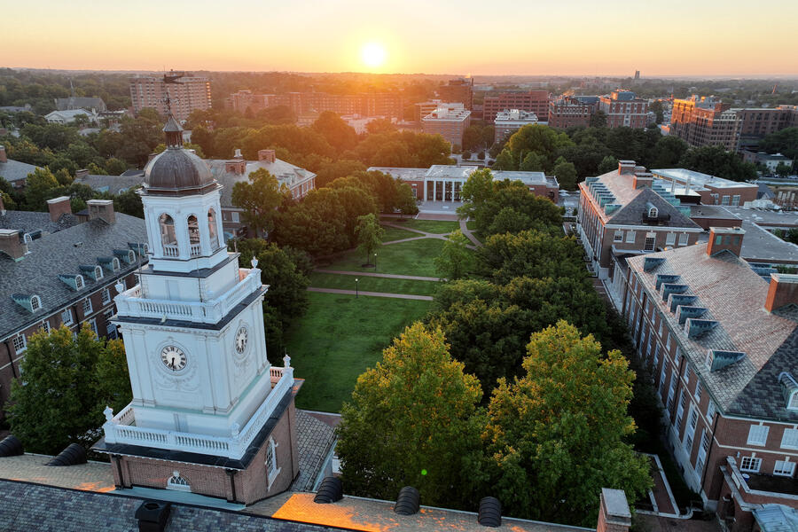 Sun rises over a campus and city skyline