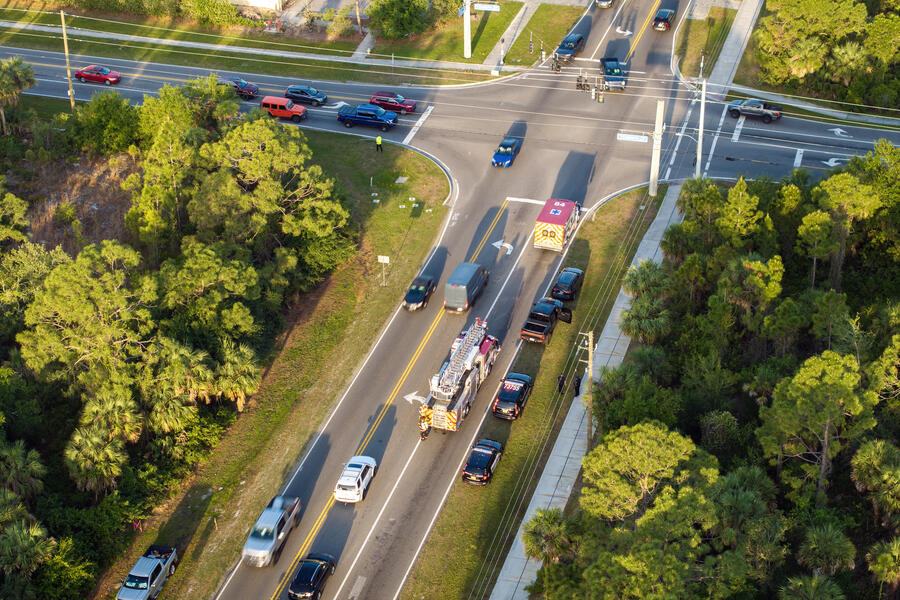 Emergency responders assist victims at vehicle crash site on city street in Florida