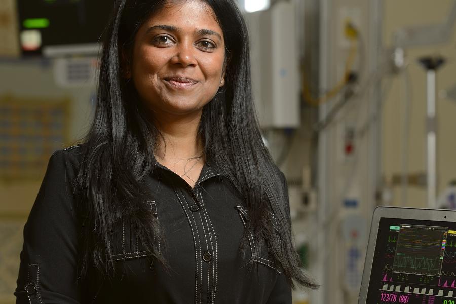 Suchi Saria with a laptop computer